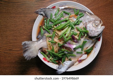 Top View Home-cooked Steamed Fish With Ginger, Spring Onion And Soya Sauce, Traditional Chinese Food.