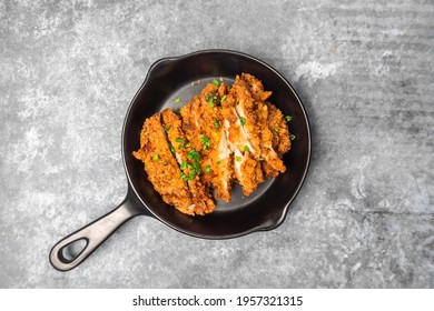 Top View Homemade Breaded Fried Chicken Chop Topped Spring Onion On The Mini Black Pan  