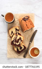 Top View Homemade Chocolate And Vanilla Marble Loaf Cake. Sliced Served With Tea Or Coffe. White Background