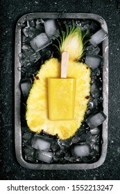 Top View Of Homemade Frozen Popsicle With Fresh Pineapple On Metal Tray Full Of Ice Cubes. Rustic Style. Summer Dessert.