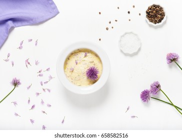 Top view of homemade herbal butter with fresh eatable chive blossoms in bowl on white background. Healthy food. - Shutterstock ID 658582516