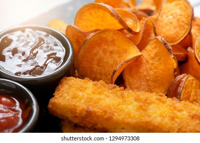 Top View Homemade Organic Baked Fried Sweet Potatoes Chips And Fish Fingers Served Home Made Tomato Sauce And Barbecue Sauce On Black Slate Plate, Healthy Snack For Family Concept