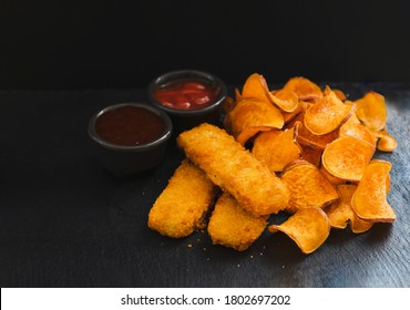 Top View Homemade Organic Baked Fried Sweet Potatoes Chips And Fish Fingers Served Home Made Tomato Sauce And Barbecue Sauce On Black Slate Plate, Healthy Snack For Family Concept