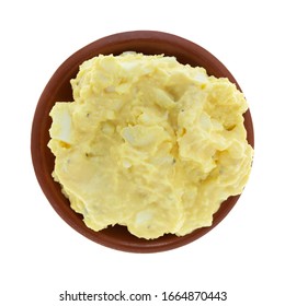 Top View Of Homemade Potato Salad With Mustard And Mayonnaise In A Small Clay Bowl Isolated On A White Background.