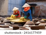 Top view of Homemade soy sauce facility in Vietnam. Two woman are making Ban soya sauce at Ban Ward, Hung Yen province, Vietnam.Soya sauce is a traditional dish of the Vietnamese people Travel concept