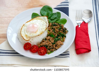 Top view of Homemade Stir fried minced pork with basil served with steamed jasmin rice and fired egg, Thai famous spicy food, Thai name is Pad kra pao Kai dow