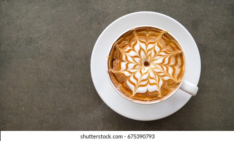 Top view of hot coffee cappuccino latte art top view on concrete table background 