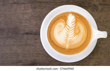 Top View Of Hot Coffee Latte Art On Wood Table