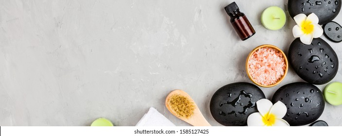 Top view of hot spa stones set for massage treatment on gray concrete background with copy space. Elegant and luxury spa. Flat lay, overhead, mock up, template. Health and beauty care concept - Powered by Shutterstock