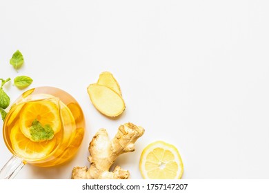 top view of hot tea near ginger root, lemon and mint on white background - Powered by Shutterstock