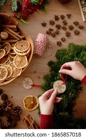 Top view of human hands making Christmas wreath                               