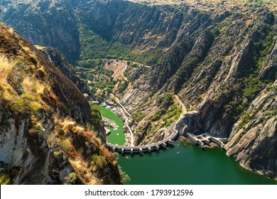 Top view of the hydroelectric dam from the viewpoint of El Fraile, natural landscape with the valley and the Duero river. Flight of birds of prey, Salamanca, Spain