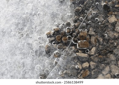 Top view ice with bubbles of river water.