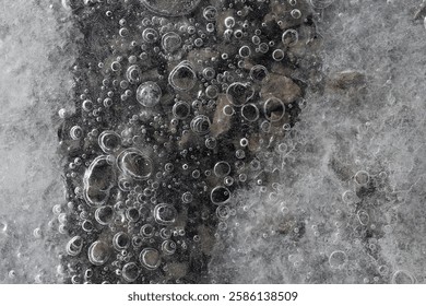 Top view ice with bubbles of river water.