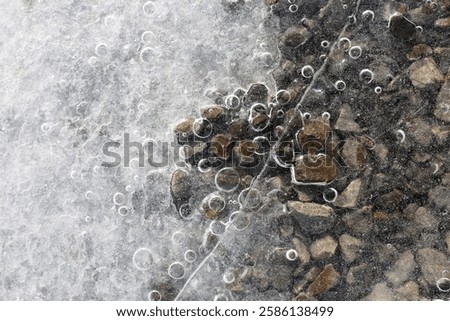 Top view ice with bubbles of river water.
