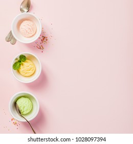 Top View Of Ice Cream In White Bowls On Pink Shabby Chic Vintage Background. Pink (strawberry), Yellow (mango Or Banana) And Green (lime, Green Tea Or Pistachio).