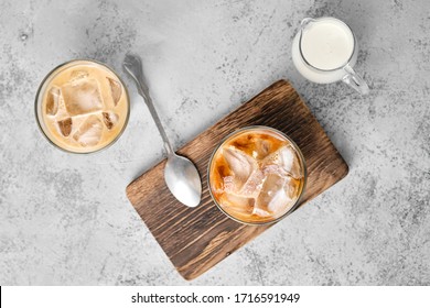 Top view of iced coffee with fat cream in rocks glass