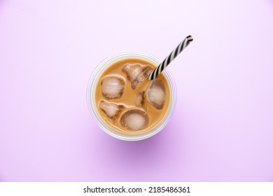 Top View Of Iced Coffee In A Take Away Mug. Purple Background.