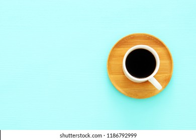 Top View Image Of Coffe Cup Over Wooden Mint Blue Background. Flat Lay. Copy Space