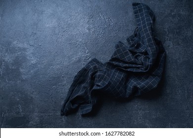 Top View Image With Dark Textured Kitchen Table And Black Checkered Cotton Towel. Flatlay With Copy Space                               