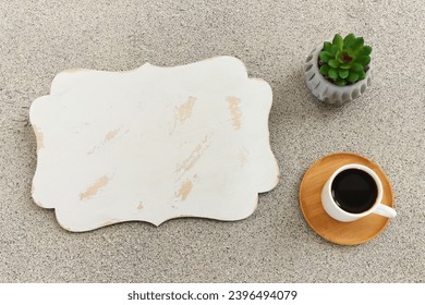 Top view image of empty board on table next to coffee cup