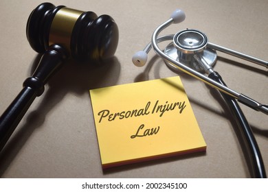 Top view image of gavel and stethoscope with Personal Injury Law wording. Law medical concept. - Shutterstock ID 2002345100