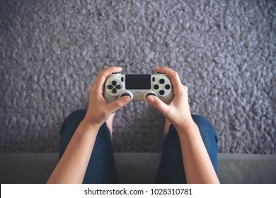 Top View Image Of Hands Holding The Game Controller While Playing Games 