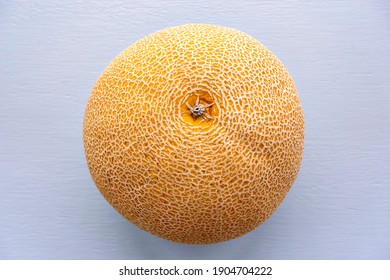 Top View Image Of Honeydew Melon With Skin Texture On A Light Background. Honeydew Melon Is The Fruit Of One Cultivar Group Of The Muskmelon, Cucumis Melo In The Gourd Family.