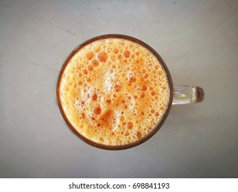 Top View Image Of Isolated Milked Bubble Tea In Glass On White Table. Only Milked Tea In Focus. Natural Light From Left Side.