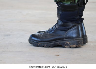 Top view image, light and shade Male soldiers wear black shoes standing on the floor during the day time. Copy area Selectable focus