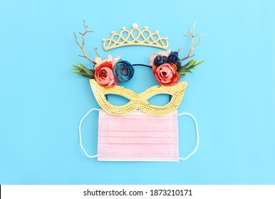 Top view image of masquerade mask background. Flat lay. Purim celebration (jewish carnival holiday). Coronavirus prevention concept, medical mask