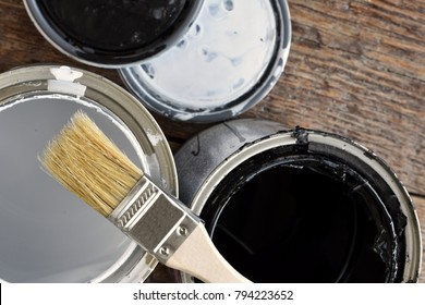 Top view image of old empty paint cans and paint brush