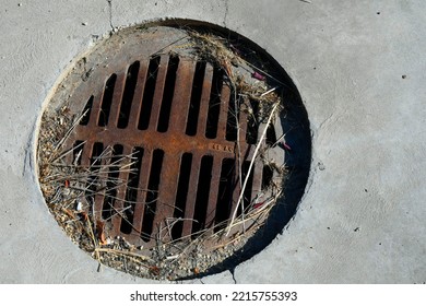 A Top View Image Of An Old Rusted And Dirty Storm Drain Cover.