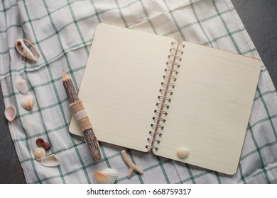 top view image of open notebook with blank pages on floor.