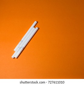 A top view image of several commercially made cigarettes.