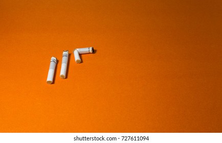 A top view image of several commercially made cigarettes.