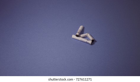 A top view image of several commercially made cigarettes.