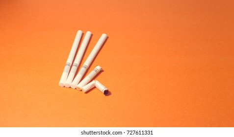 A top view image of several commercially made cigarettes.
