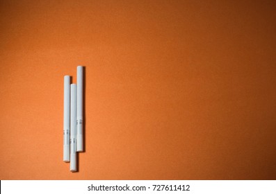 A top view image of several commercially made cigarettes.