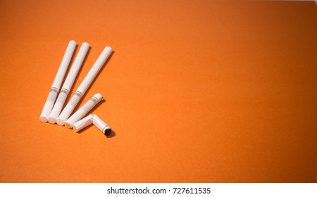 A top view image of several commercially made cigarettes.