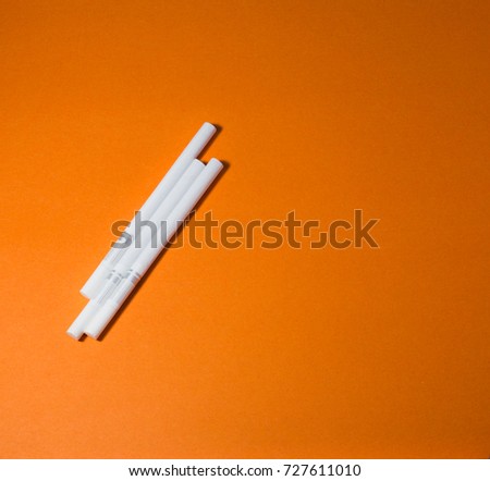 A top view image of several commercially made cigarettes.
