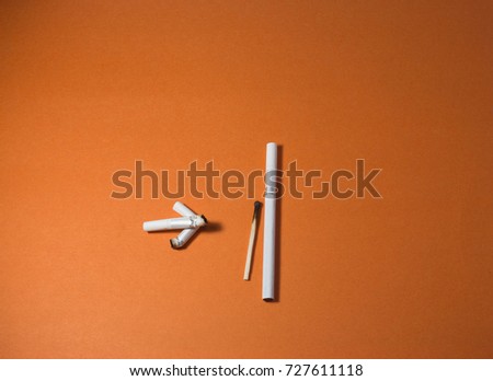 A top view image of several commercially made cigarettes.