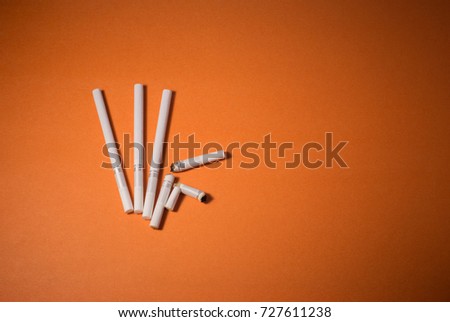 A top view image of several commercially made cigarettes.