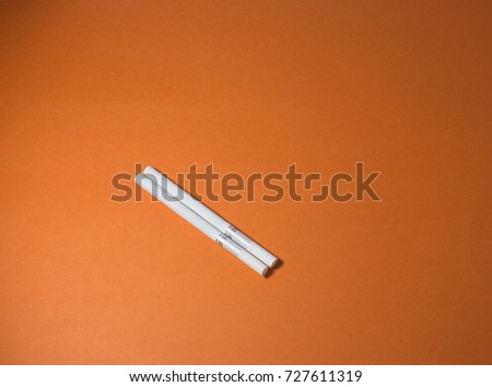 A top view image of several commercially made cigarettes.