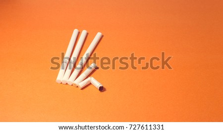 A top view image of several commercially made cigarettes.