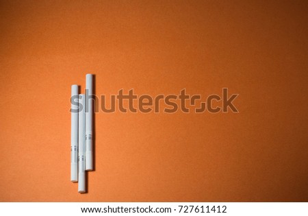 A top view image of several commercially made cigarettes.