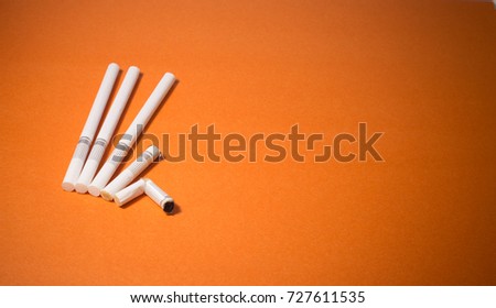 A top view image of several commercially made cigarettes.