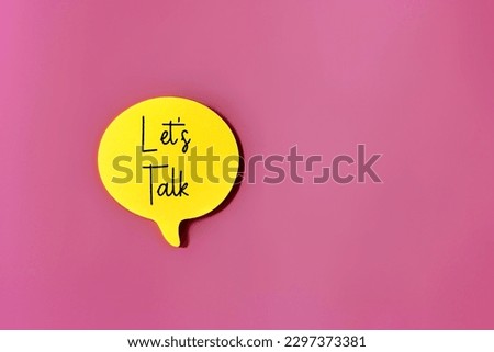 Top view image of speech bubble with text LET'S TALK on pink background with copy space. 