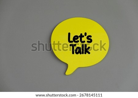 Top view image of speech bubble with text LET'S TALK on grey background with copy space. 
