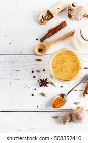 Top view image of turmeric latte and spices with copyspace